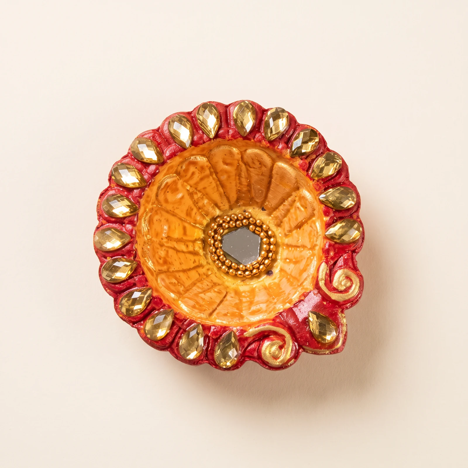 Orange & Red Embellished Diya — handmade details on an ivory background